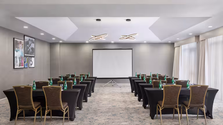 Hotel meeting room set classroom style with a screen